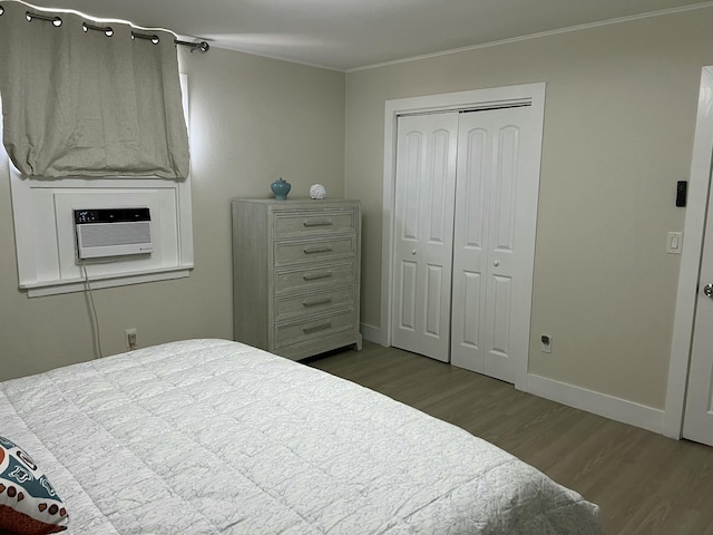 bedroom with hardwood / wood-style flooring, a closet, and ornamental molding