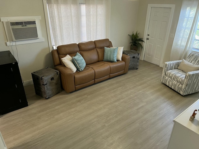 living room with light hardwood / wood-style flooring and a wall mounted AC