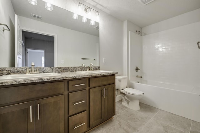 full bathroom featuring a textured ceiling, vanity, toilet, and shower / washtub combination