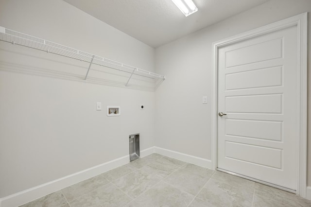 clothes washing area with electric dryer hookup, a textured ceiling, and hookup for a washing machine