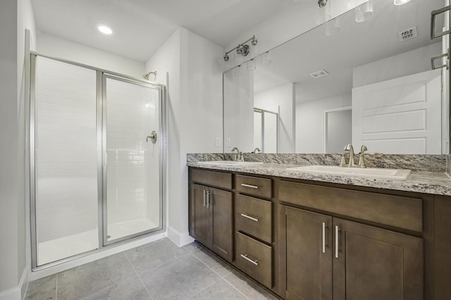 bathroom featuring tile patterned floors, vanity, and walk in shower