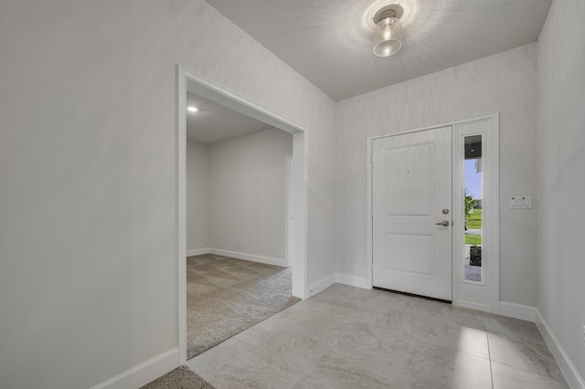 view of carpeted entrance foyer