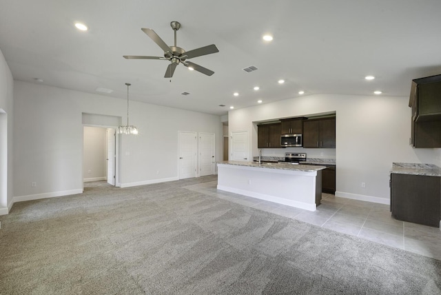 kitchen with light carpet, ceiling fan with notable chandelier, sink, dark brown cabinetry, and stainless steel appliances