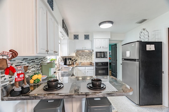 kitchen featuring black appliances, white cabinets, sink, tasteful backsplash, and kitchen peninsula