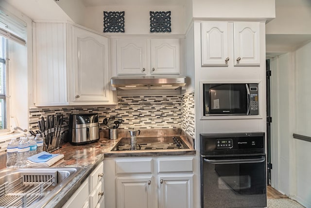 kitchen featuring black appliances, white cabinetry, sink, and tasteful backsplash