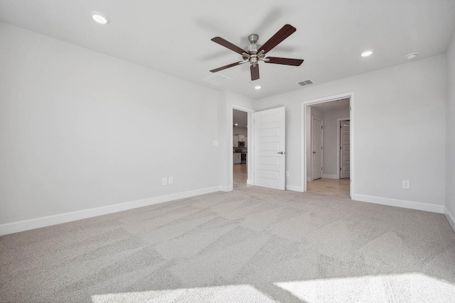 unfurnished bedroom with light colored carpet and ceiling fan