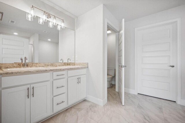 bathroom with vanity and toilet