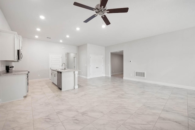 kitchen with ceiling fan, white cabinetry, sink, an island with sink, and appliances with stainless steel finishes