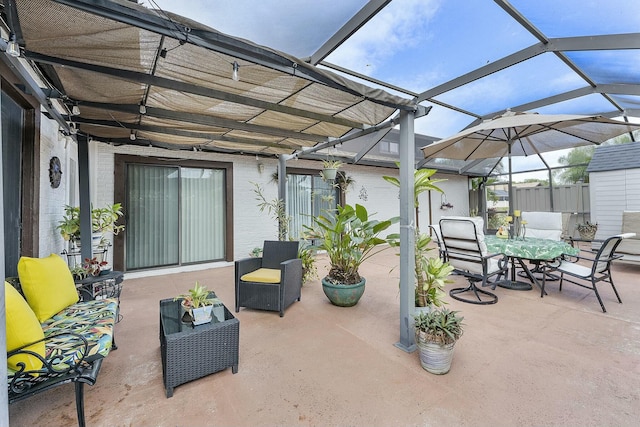 view of patio featuring glass enclosure