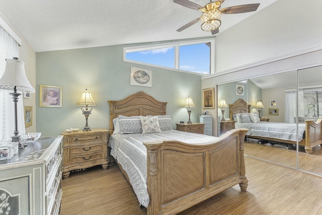 bedroom featuring wood-type flooring, a textured ceiling, a closet, and ceiling fan