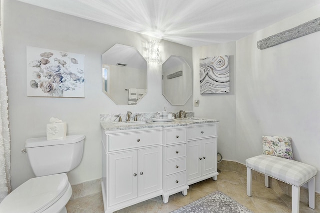 bathroom with tile patterned floors, vanity, and toilet