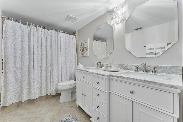 bathroom featuring toilet, vanity, and tile patterned floors