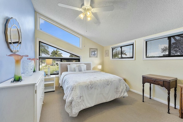 bedroom with a textured ceiling, light colored carpet, and ceiling fan