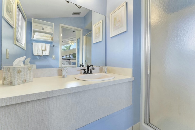 bathroom featuring a shower with shower door, lofted ceiling, and vanity