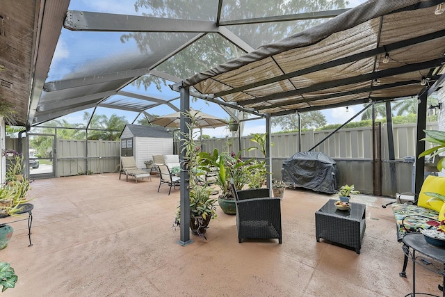 view of patio with grilling area, a storage unit, and a lanai