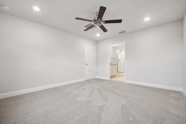 unfurnished bedroom featuring connected bathroom, ceiling fan, and light carpet