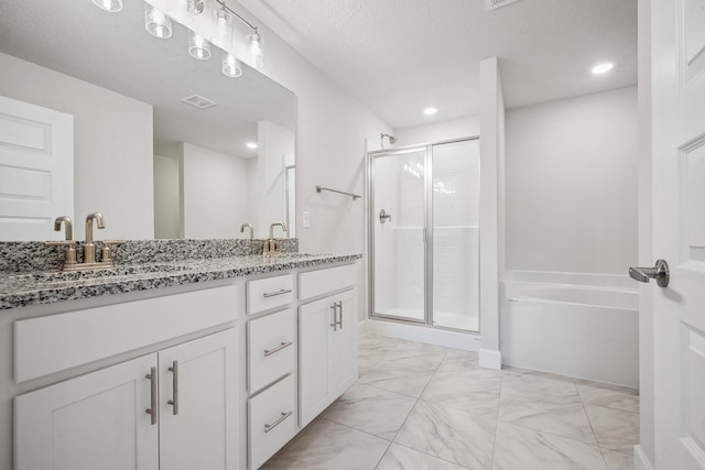 bathroom with vanity, a textured ceiling, and plus walk in shower