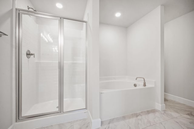 bathroom with separate shower and tub