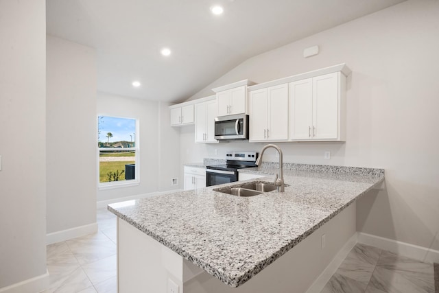 kitchen featuring light stone countertops, stainless steel appliances, kitchen peninsula, lofted ceiling, and white cabinets