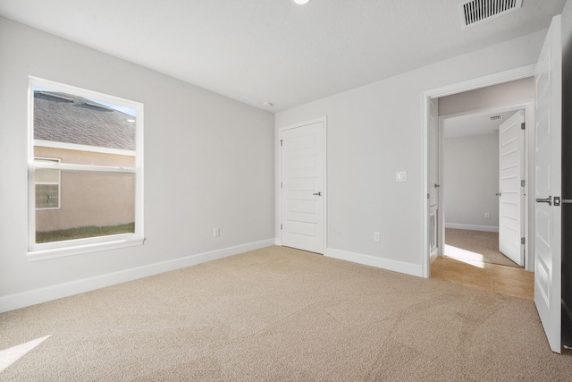 unfurnished bedroom with light carpet