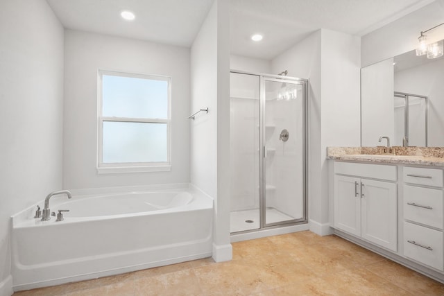 bathroom featuring vanity and shower with separate bathtub