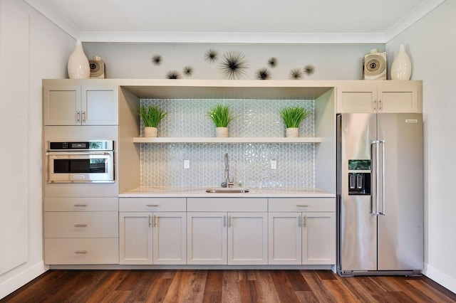 kitchen with decorative backsplash, open shelves, appliances with stainless steel finishes, and a sink