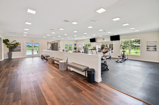 gym with visible vents, french doors, baseboards, and wood finished floors