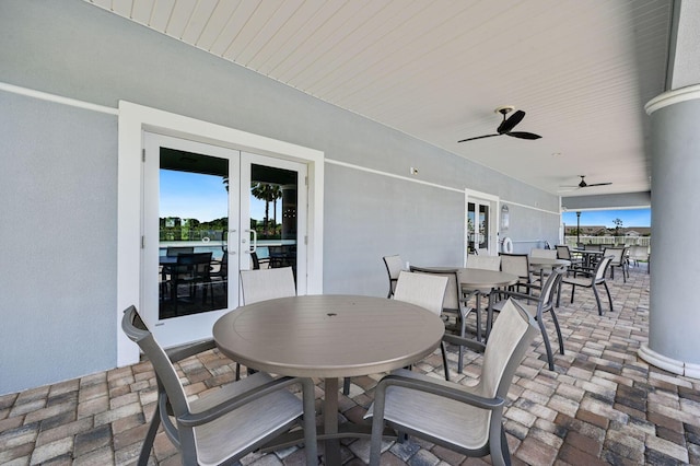 view of patio featuring ceiling fan, french doors, and outdoor dining space
