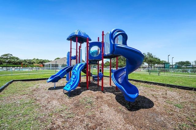communal playground with fence and a lawn