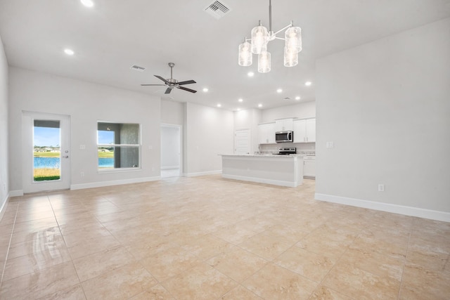 unfurnished living room featuring light tile patterned flooring and ceiling fan with notable chandelier