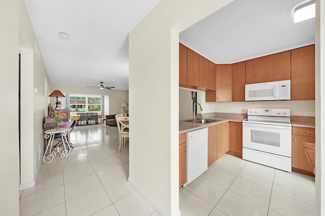 kitchen featuring ceiling fan, white appliances, sink, and light tile patterned floors