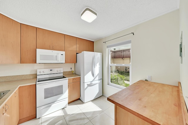 kitchen with white appliances, a textured ceiling, and light tile patterned floors