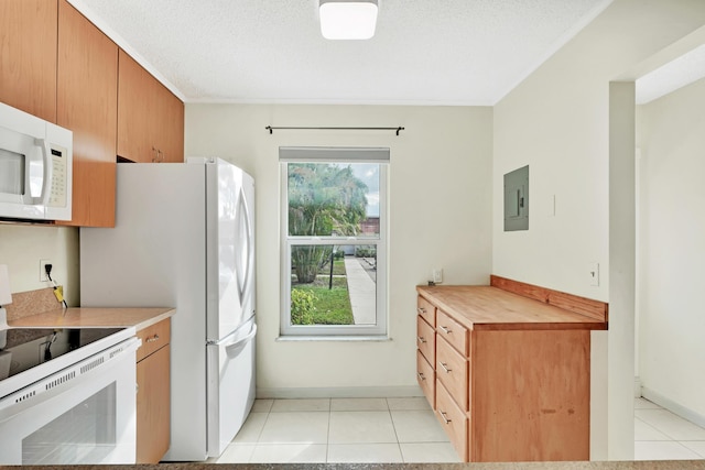 kitchen featuring stove, light tile patterned floors, a healthy amount of sunlight, and wooden counters