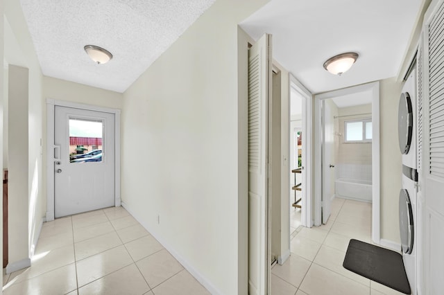 hallway featuring light tile patterned floors and a textured ceiling