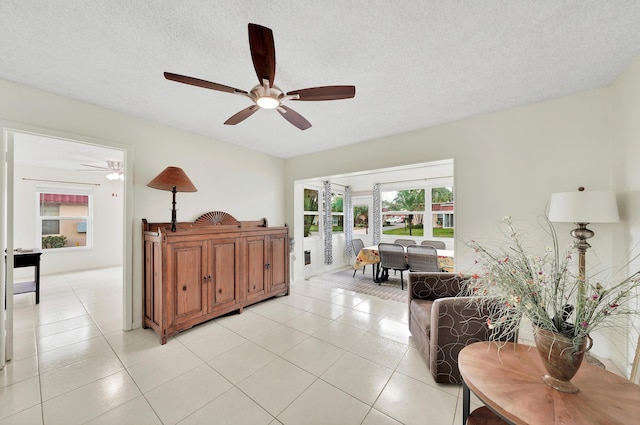 tiled bedroom featuring a textured ceiling and ceiling fan