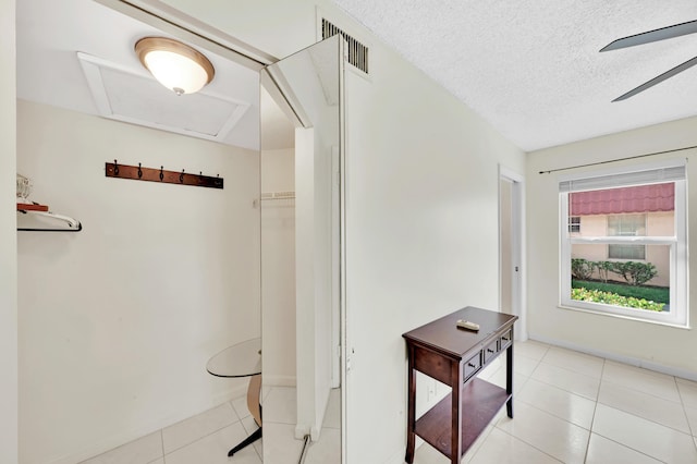 bathroom featuring tile patterned flooring, ceiling fan, and a textured ceiling