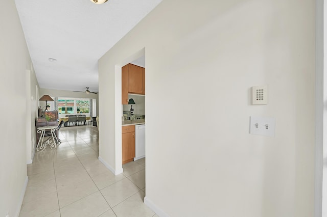 hall featuring light tile patterned floors