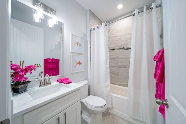 full bathroom with vanity, shower / tub combo, and toilet