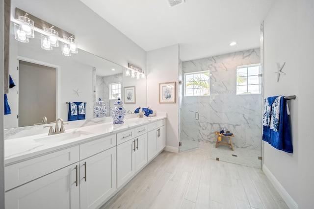 bathroom with vanity, hardwood / wood-style flooring, and a shower with shower door