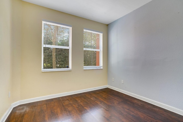 unfurnished room with dark hardwood / wood-style floors