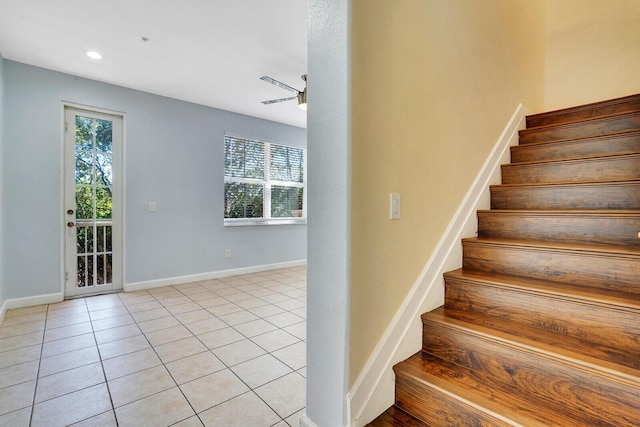 stairs with tile patterned flooring and ceiling fan