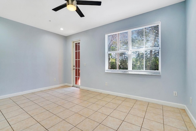 spare room with light tile patterned floors and ceiling fan