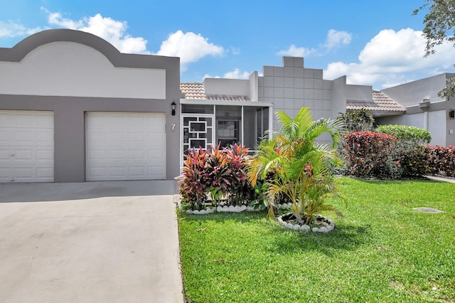 view of front of house with a garage and a front yard