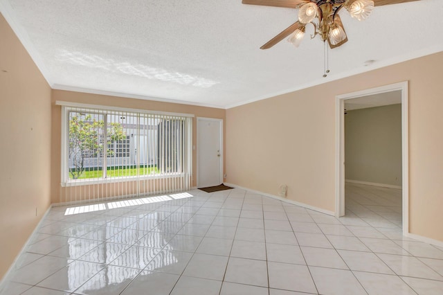 spare room featuring ceiling fan, light tile patterned floors, a textured ceiling, and ornamental molding