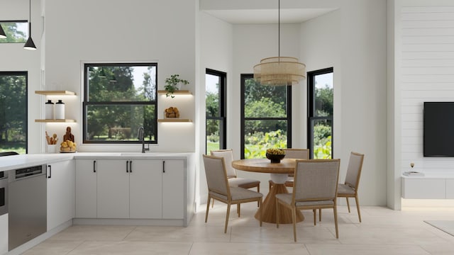 interior space with white cabinetry, dishwasher, hanging light fixtures, and a notable chandelier