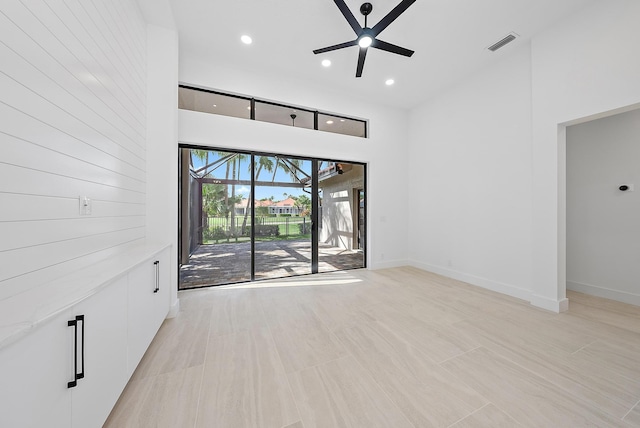 unfurnished living room featuring ceiling fan