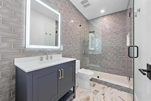 bathroom featuring vanity, an enclosed shower, tile walls, and toilet