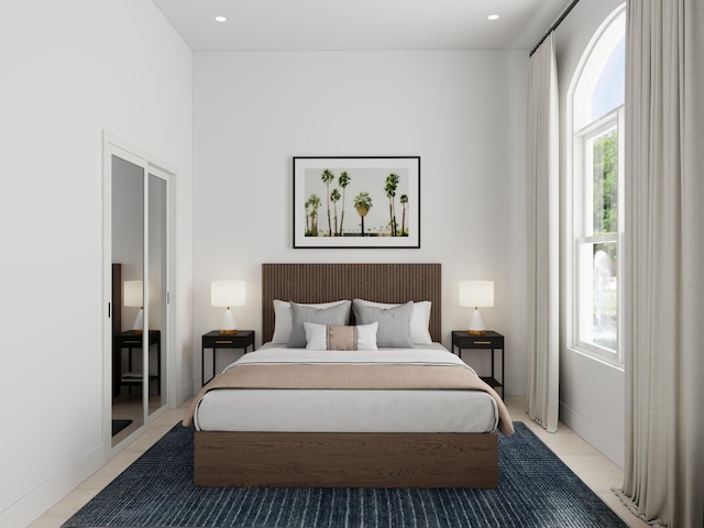 bedroom featuring light tile patterned floors and multiple windows