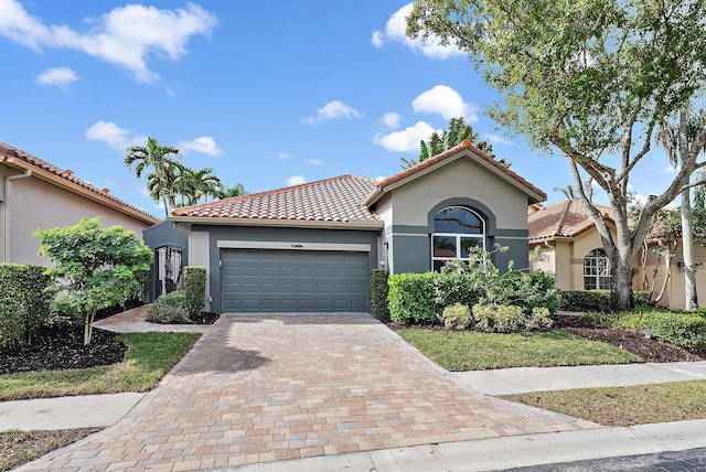 mediterranean / spanish-style house with a garage