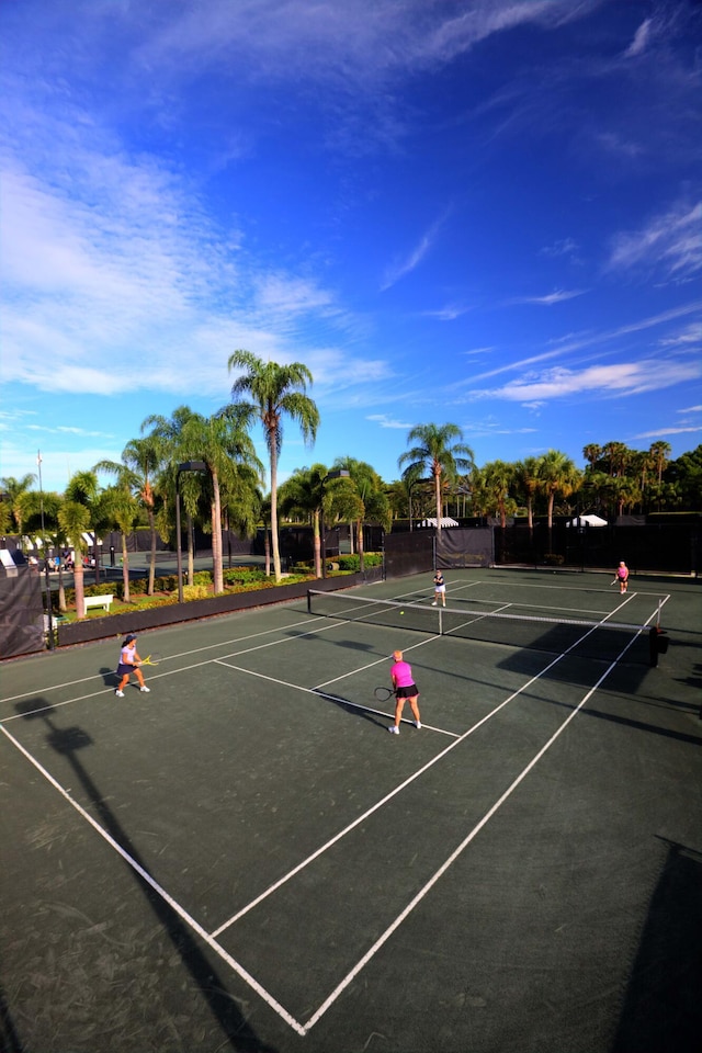 view of tennis court featuring basketball hoop